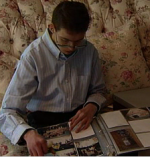 Adam looking through a photo album
